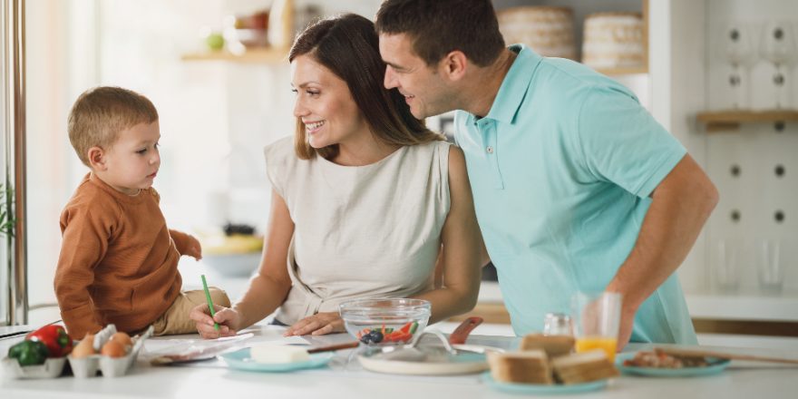 A family having breakfast together in a kitchen.